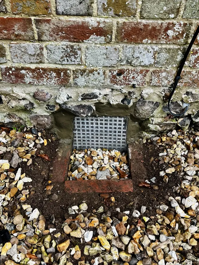 Metal mesh fitted over a low external vent